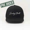 Black cap with 'Sunday Stroll' text on a white background, featuring a 'Pre Order' label.