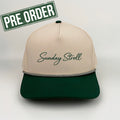 Beige and green cap with 'Sunday Stroll' text on a light gray background, featuring a 'Pre Order' label.